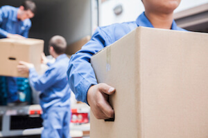 Men unloading boxes from moving truck