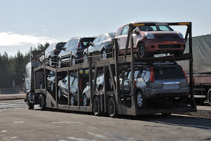 Auto transport truck shipping cars at a rest stop along freeway