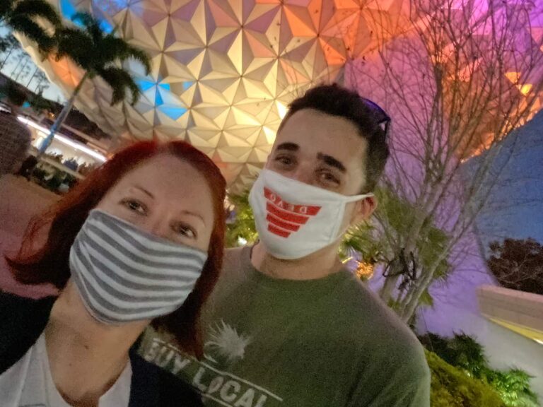 A couple posing for a selfie at Epcot theme park.