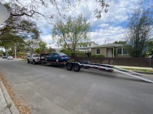 car getting loaded onto trailer