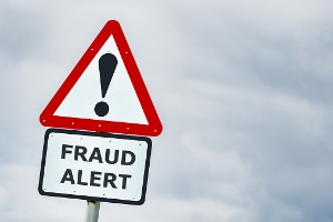 A road sign that says "fraud alert"