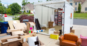 moving container loaded and surrounded with moving items and boxes