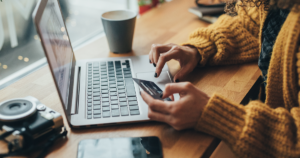 person entering credit card information on laptop