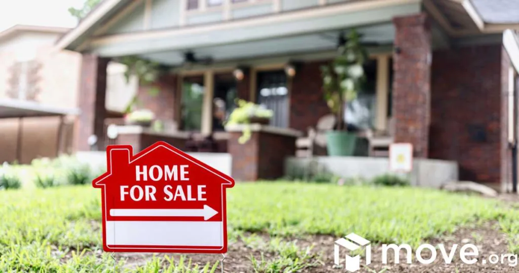 A house with a for sale sign in the yard.