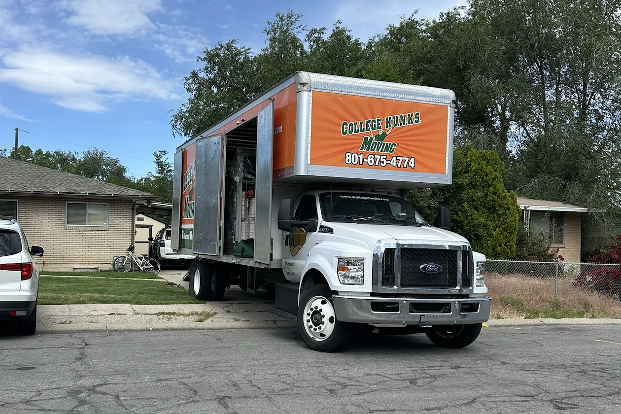 Zippy Shell’s local partner College Hunks Moving truck in a driveway ready to load up.